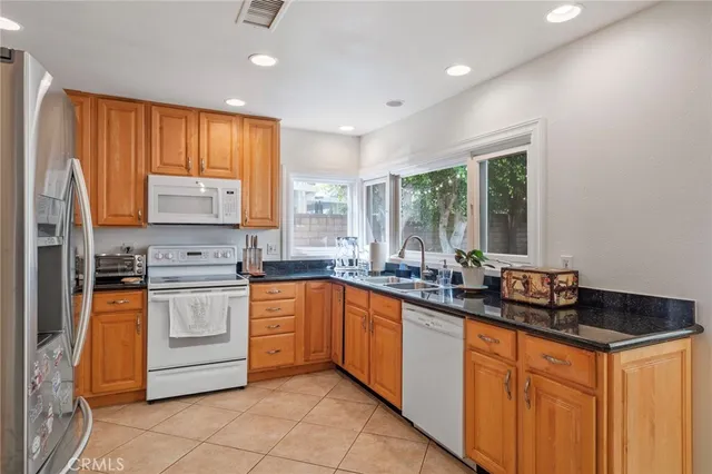 a kitchen with stainless steel appliances a sink stove and cabinets