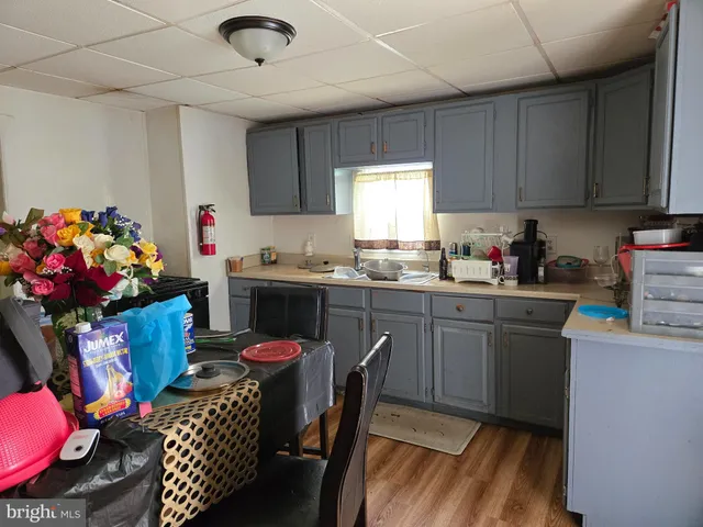 a kitchen with granite countertop a sink cabinets and window
