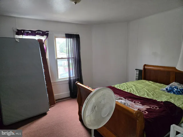 a bed room with a bed and a mirror