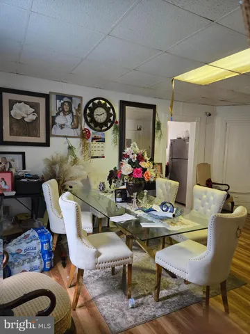 a dining room with furniture and wooden floor