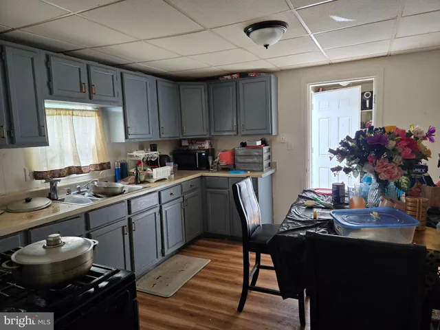 a kitchen with a sink appliances and cabinets