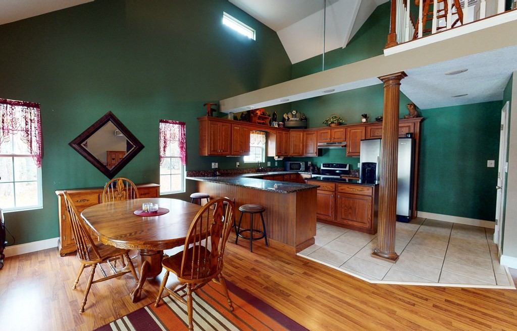 1365 No Pone Valley Road Northwest Georgetown, TN 37336 - Photo 7 of 48 a kitchen with stainless steel appliances kitchen island granite countertop dining table chairs and a large window
