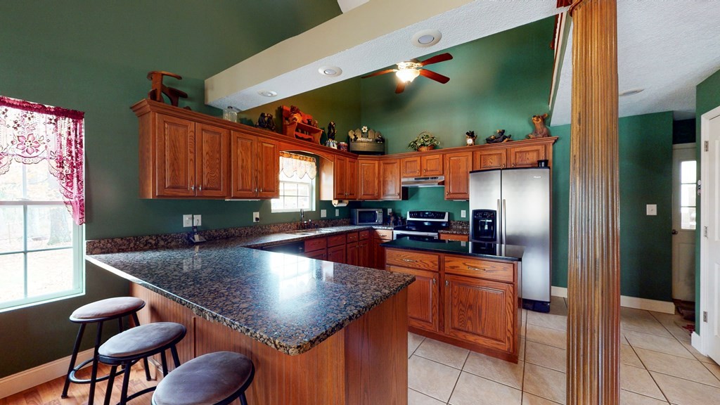 1365 No Pone Valley Road Northwest Georgetown, TN 37336 - Photo 10 of 48 a kitchen with stainless steel appliances granite countertop a sink a counter space and cabinets
