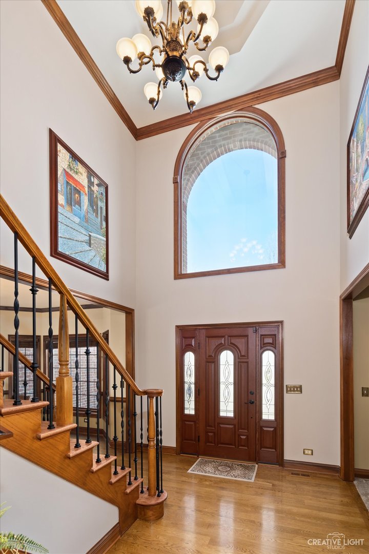 3519 Vanilla Grass Drive Naperville, IL 60564 - Photo 14 of 48 a front view of a house with entryway wooden floor and a chandelier