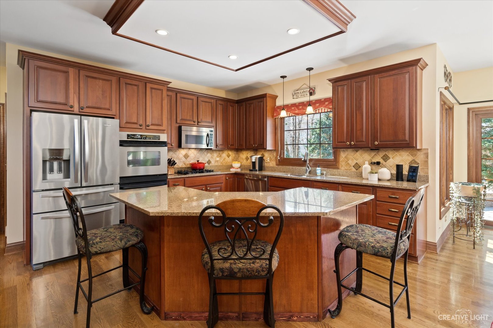 3519 Vanilla Grass Drive Naperville, IL 60564 - Photo 3 of 48 a kitchen with stainless steel appliances granite countertop a stove top oven a refrigerator a sink and chairs