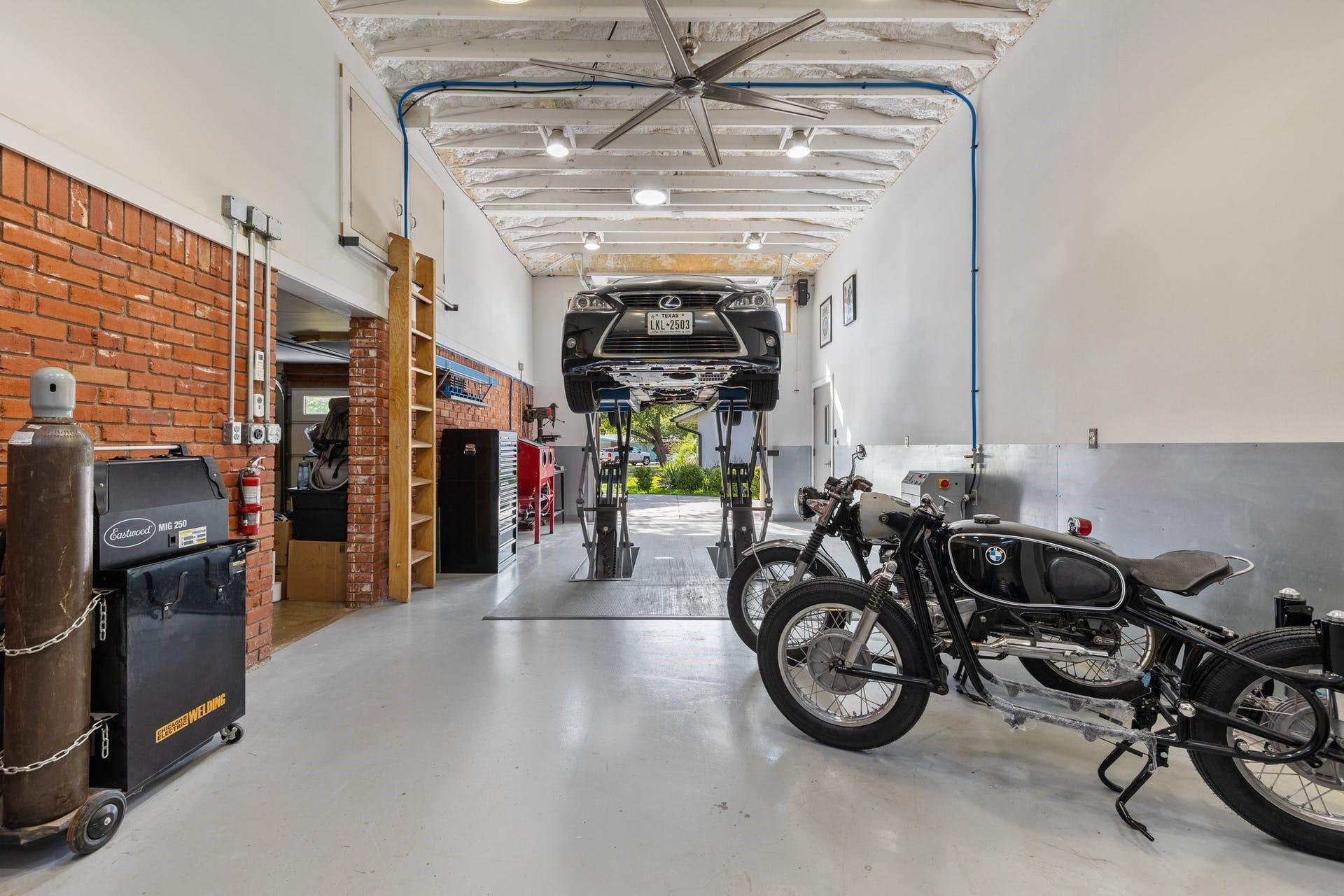 4603 Lasso Path Austin, TX 78745 - Photo 20 of 28 Garage features a car lift, creating a dream workshop for car lovers and mechanics