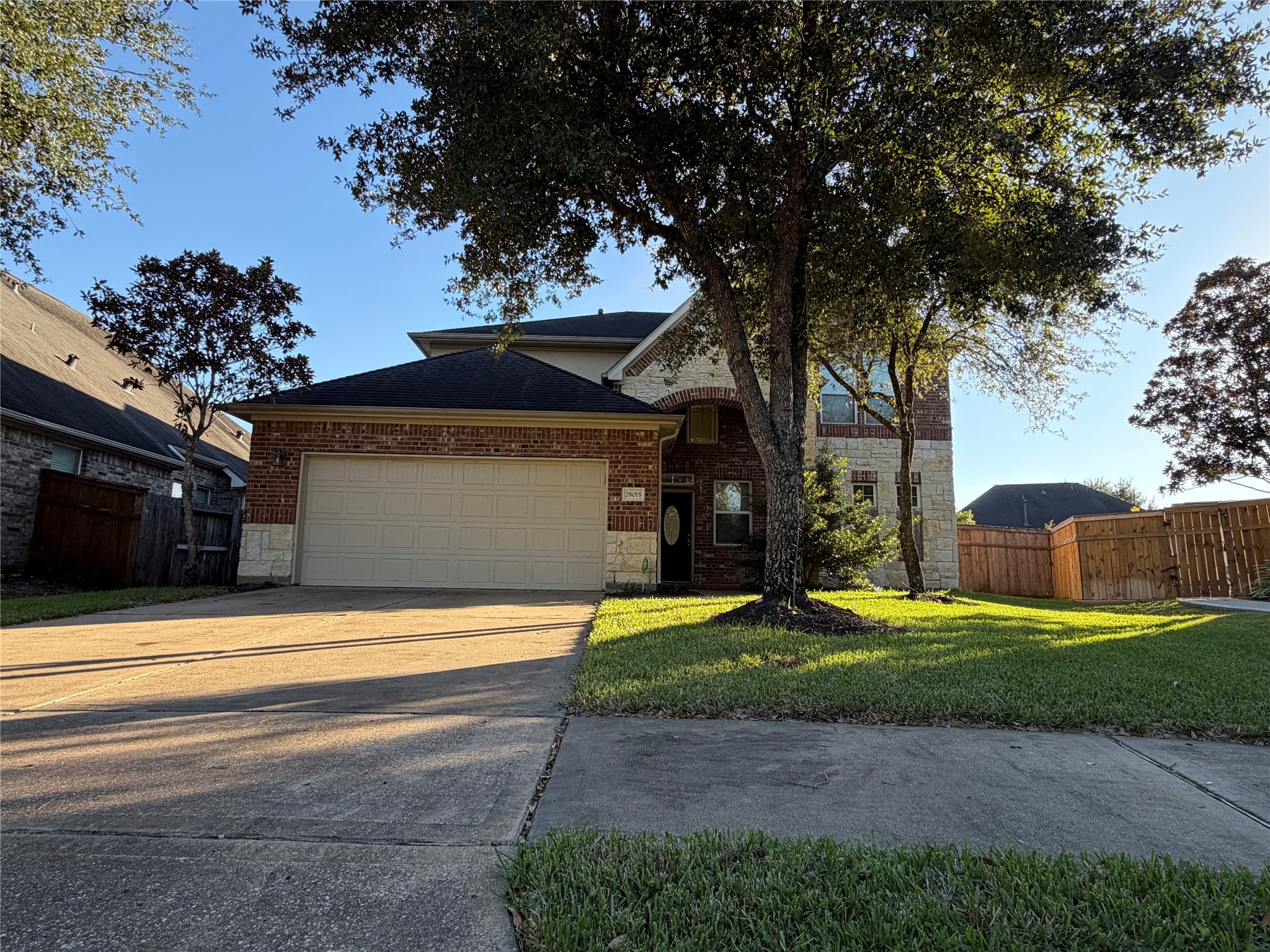 28015 Silverstream Court Fulshear, TX 77441 - Photo 1 of 33 a view of a house with entertaining space and a large tree