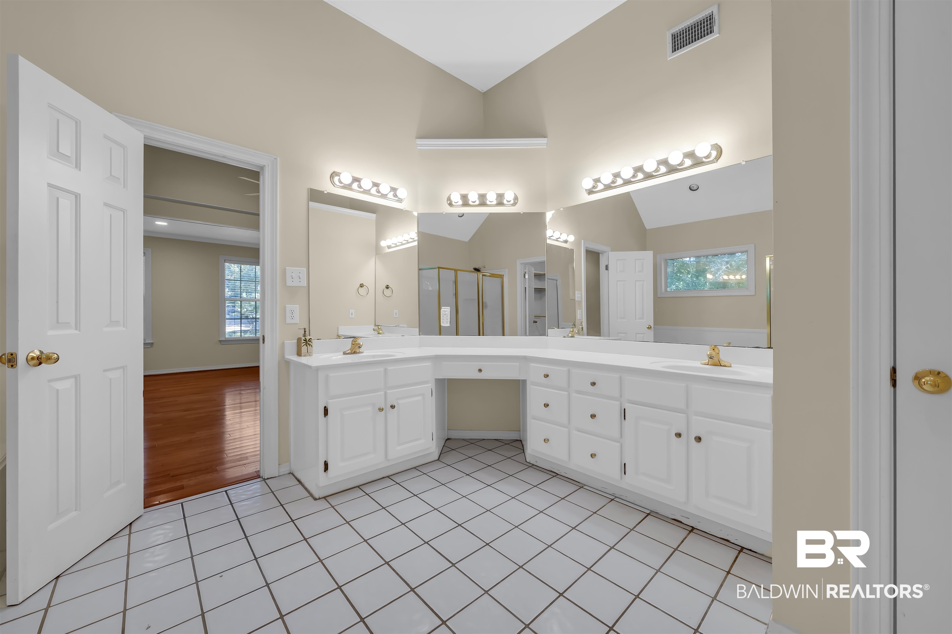 1262 Patrick Street Daphne, AL 36526 - Photo 33 of 35 Bathroom featuring double vanity, healthy amount of natural light, light tile patterned floors, lofted ceiling, and a shower stall