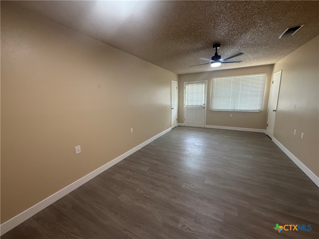 200 Olsens Acres, Unit D6 Wimberley, TX 78676 - Photo 15 of 21 an empty room with wooden floor and windows