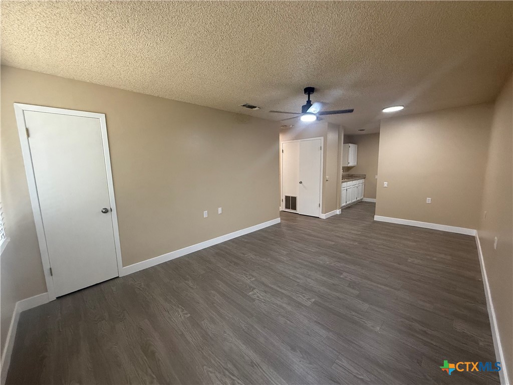 200 Olsens Acres, Unit D6 Wimberley, TX 78676 - Photo 16 of 21 an empty room with wooden floor and a ceiling fan