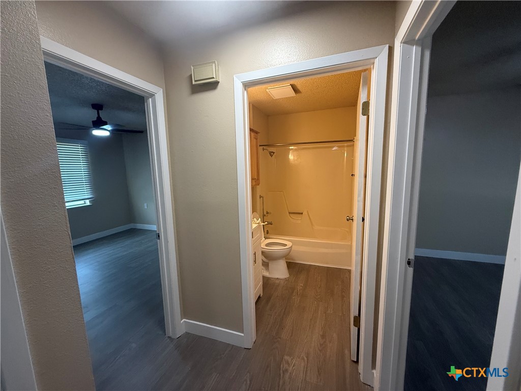 200 Olsens Acres, Unit D6 Wimberley, TX 78676 - Photo 17 of 21 view of a bathroom with a glass door and a toilet
