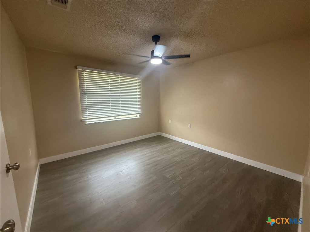 200 Olsens Acres, Unit D6 Wimberley, TX 78676 - Photo 18 of 21 an empty room with a window and a ceiling fan
