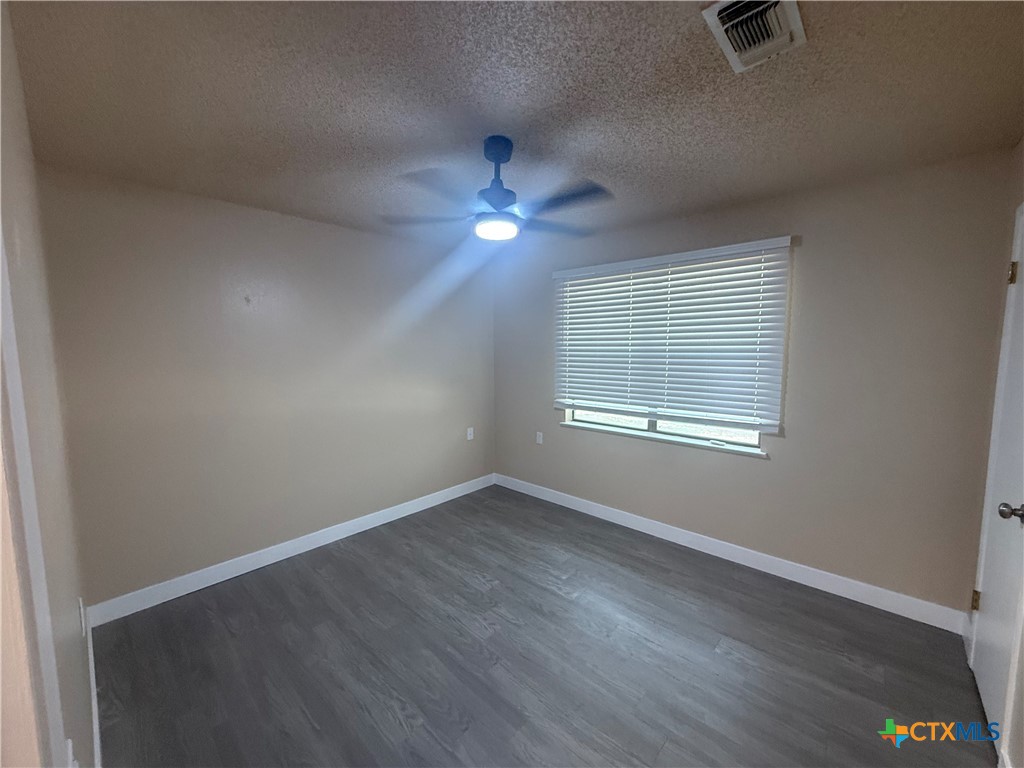 200 Olsens Acres, Unit D6 Wimberley, TX 78676 - Photo 20 of 21 an empty room with wooden floor and windows