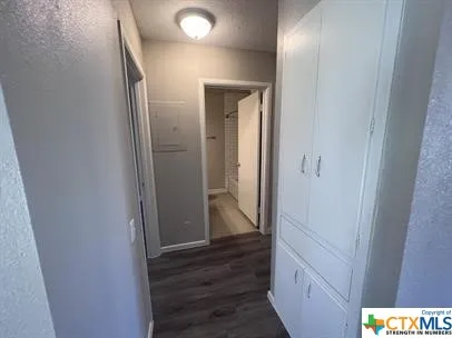 a view of hallway with wooden floor