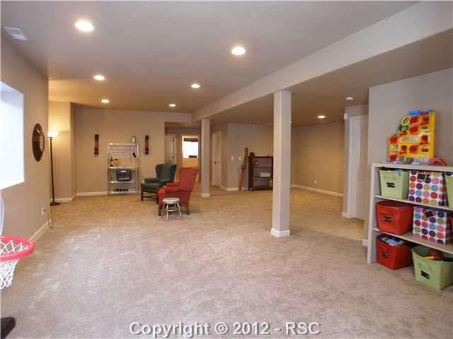 9806 Rockingham Drive Peyton, CO 80831 - Photo 14 of 16 28x19 plus 14x6 to the right rear designed/plumbed/wired for the wet bar