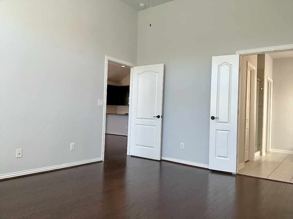 209 Penna Lane Georgetown, TX 78628 - Photo 8 of 19 an empty room with wooden floor and windows