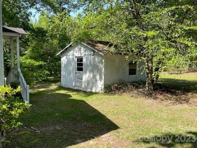 149 Robert Joyner Circle Salley, SC 29137 - Photo 44 of 48 a backyard of a house with plants and large tree