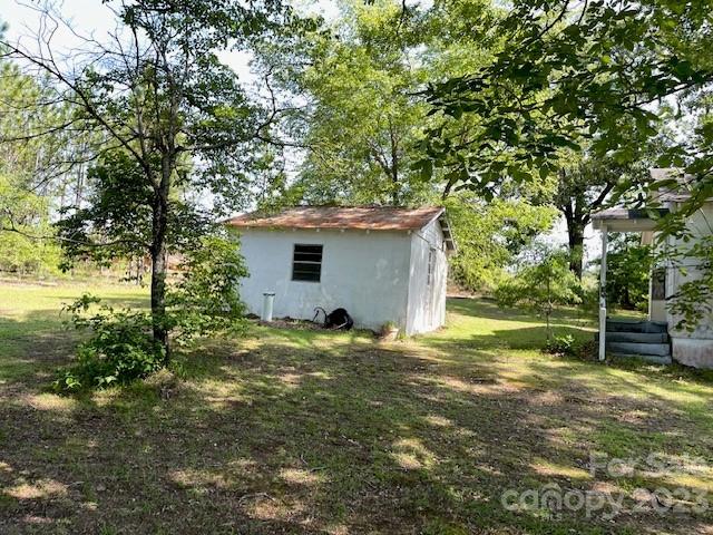 149 Robert Joyner Circle Salley, SC 29137 - Photo 10 of 48 a backyard of a house with table and chairs