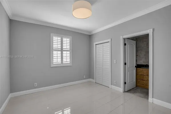 a view of an empty room and a bathroom