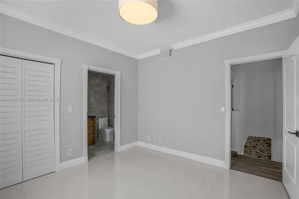 a bathroom with a granite countertop toilet and a sink