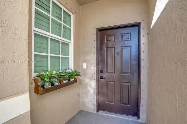 a view of a hallway with wooden door