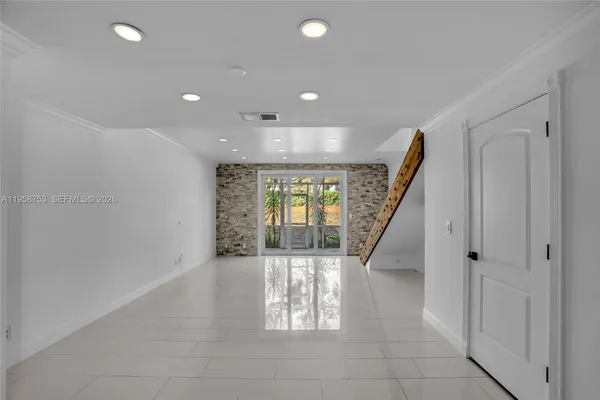 a view of entryway and hall with a living room