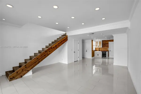 a open kitchen with kitchen island granite countertop a sink and a stove top oven