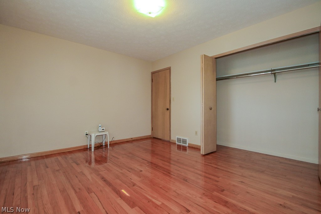 30224 Regent Road Wickliffe, OH 44092 - Photo 15 of 27 Unfurnished bedroom with light wood-style flooring and a closet