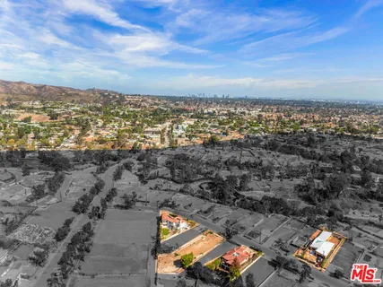 a street sign on a wall next to a road