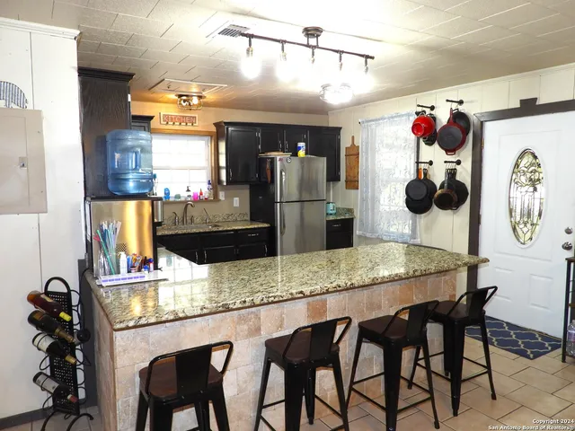 a kitchen with a sink and a refrigerator