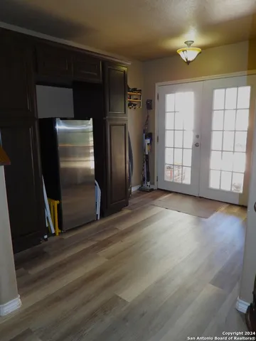 a spacious bedroom with a bed and a chandelier