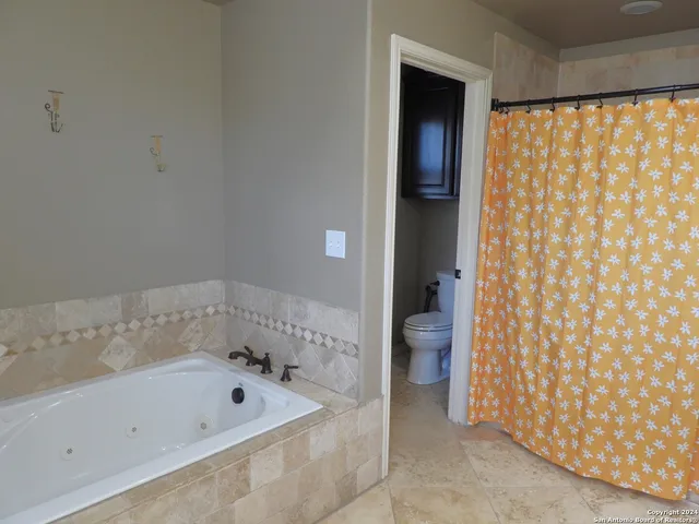 a balcony with wooden floor and yard in the back