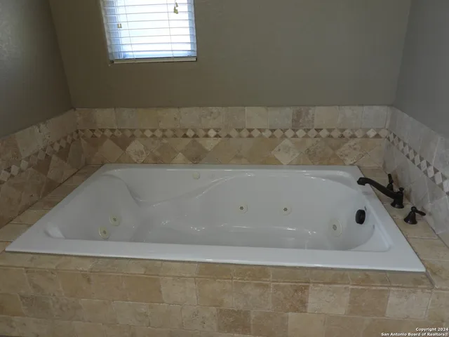 a view of a house with a door and wooden wall