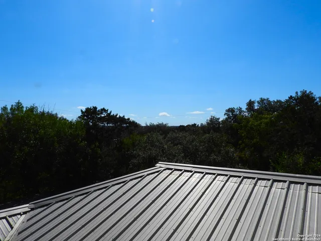 a view of a road with a tree in the background