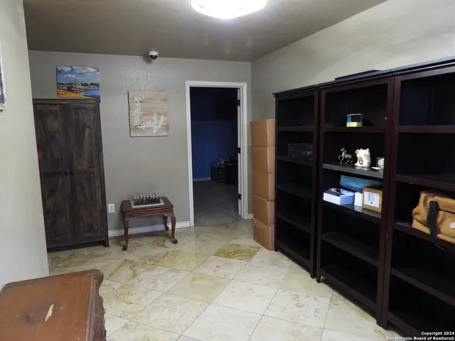 a living room with lots of furniture and a large window