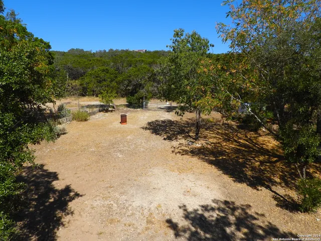 a living room with furniture and a ceiling fan