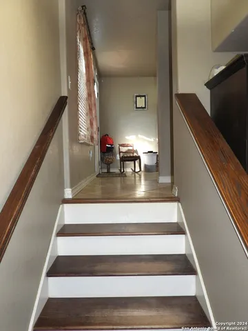a living room with furniture a flat screen tv and kitchen view