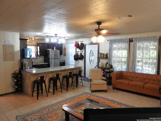 a kitchen with refrigerator and microwave
