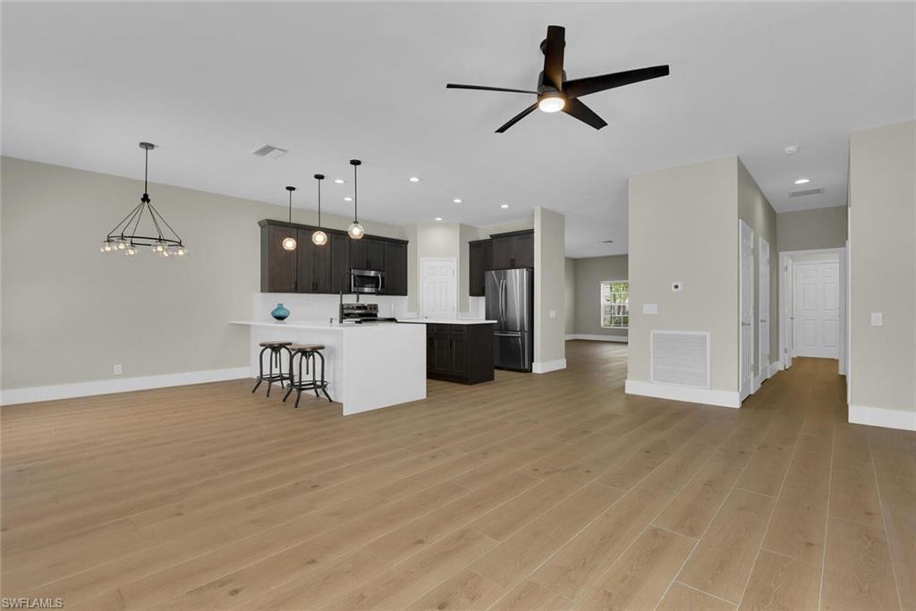 8883 Falcon Pointe Loop Fort Myers, FL 33912 - Photo 11 of 49 a living room with furniture and kitchen view