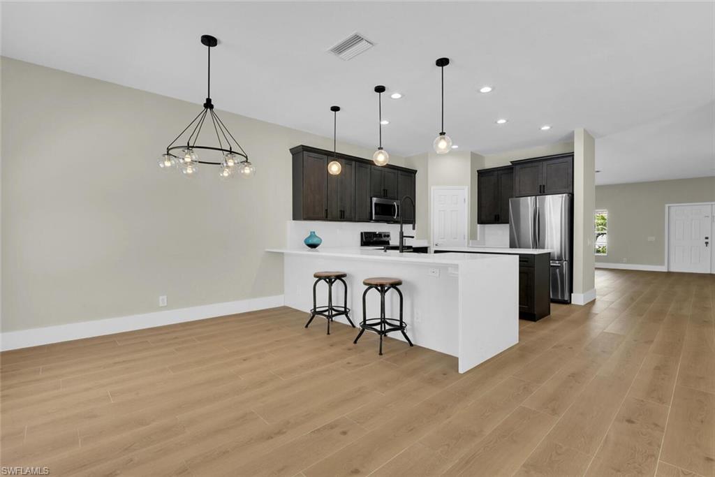 8883 Falcon Pointe Loop Fort Myers, FL 33912 - Photo 13 of 49 a view of kitchen with microwave and refrigerator