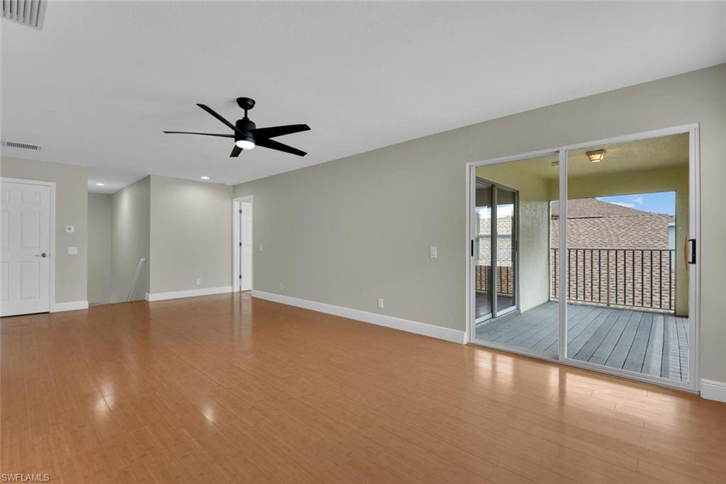 8883 Falcon Pointe Loop Fort Myers, FL 33912 - Photo 26 of 49 an empty room with wooden floor and windows