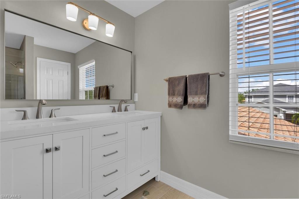 8883 Falcon Pointe Loop Fort Myers, FL 33912 - Photo 33 of 49 a bathroom with a double vanity sink and mirror