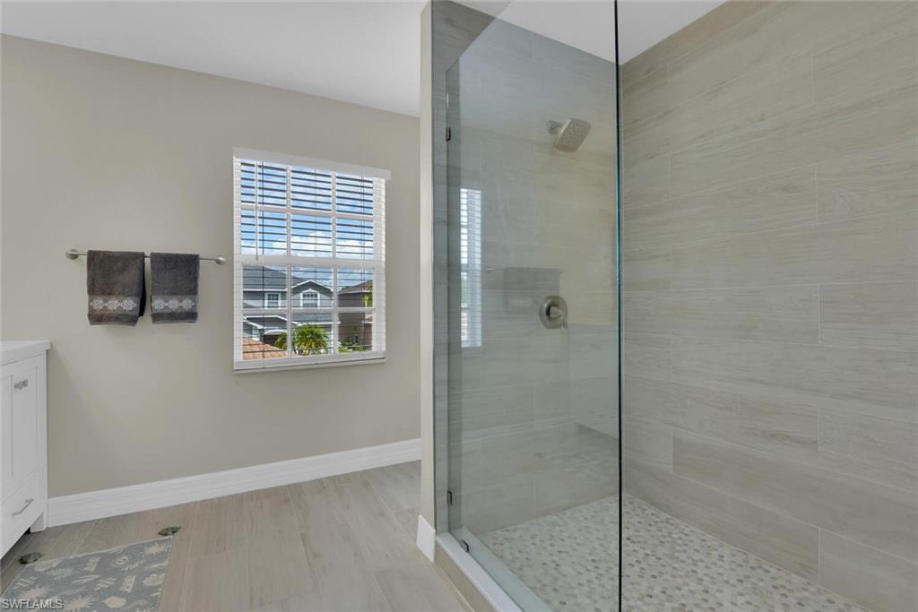 8883 Falcon Pointe Loop Fort Myers, FL 33912 - Photo 34 of 49 a bathroom with a bathtub and a shower