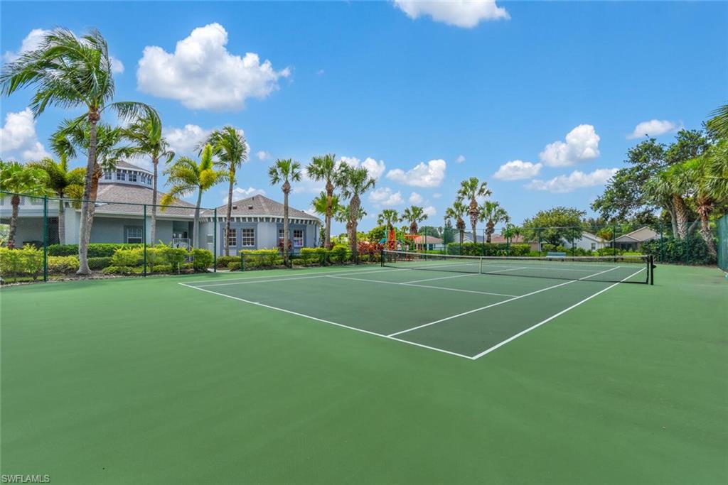 8883 Falcon Pointe Loop Fort Myers, FL 33912 - Photo 46 of 49 a view of a tennis ground with large trees