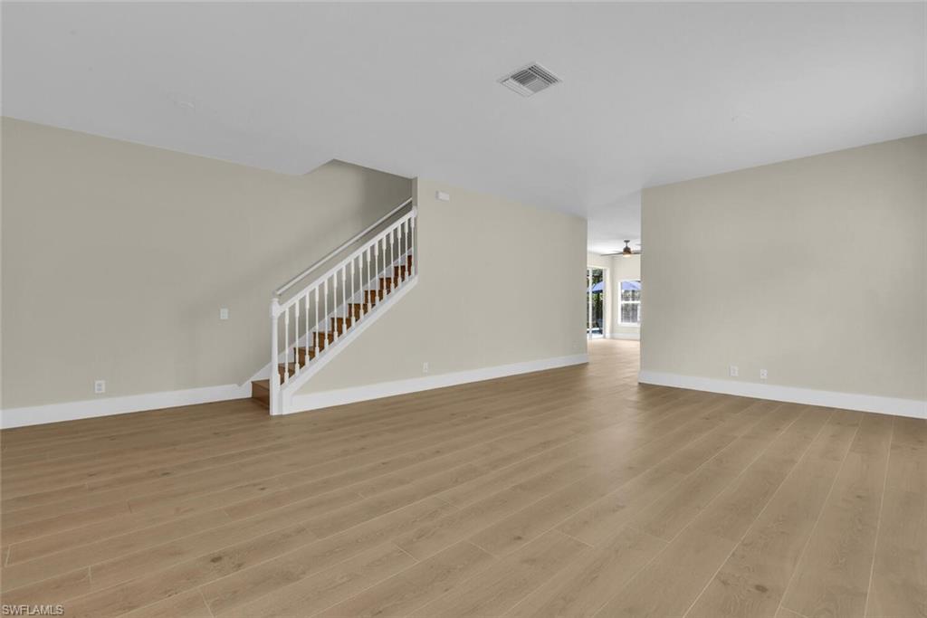 8883 Falcon Pointe Loop Fort Myers, FL 33912 - Photo 9 of 49 a view of an empty room with wooden floor