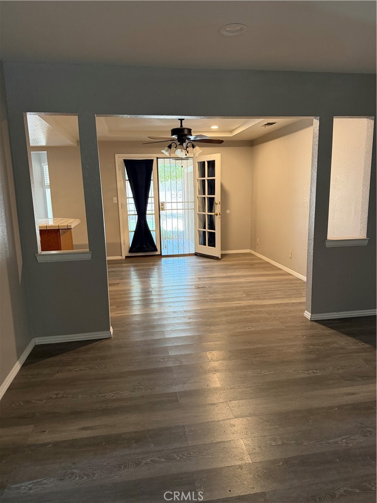 18602 Cocqui Road Apple Valley, CA 92307 - Photo 4 of 16 an empty room with wooden floor and windows