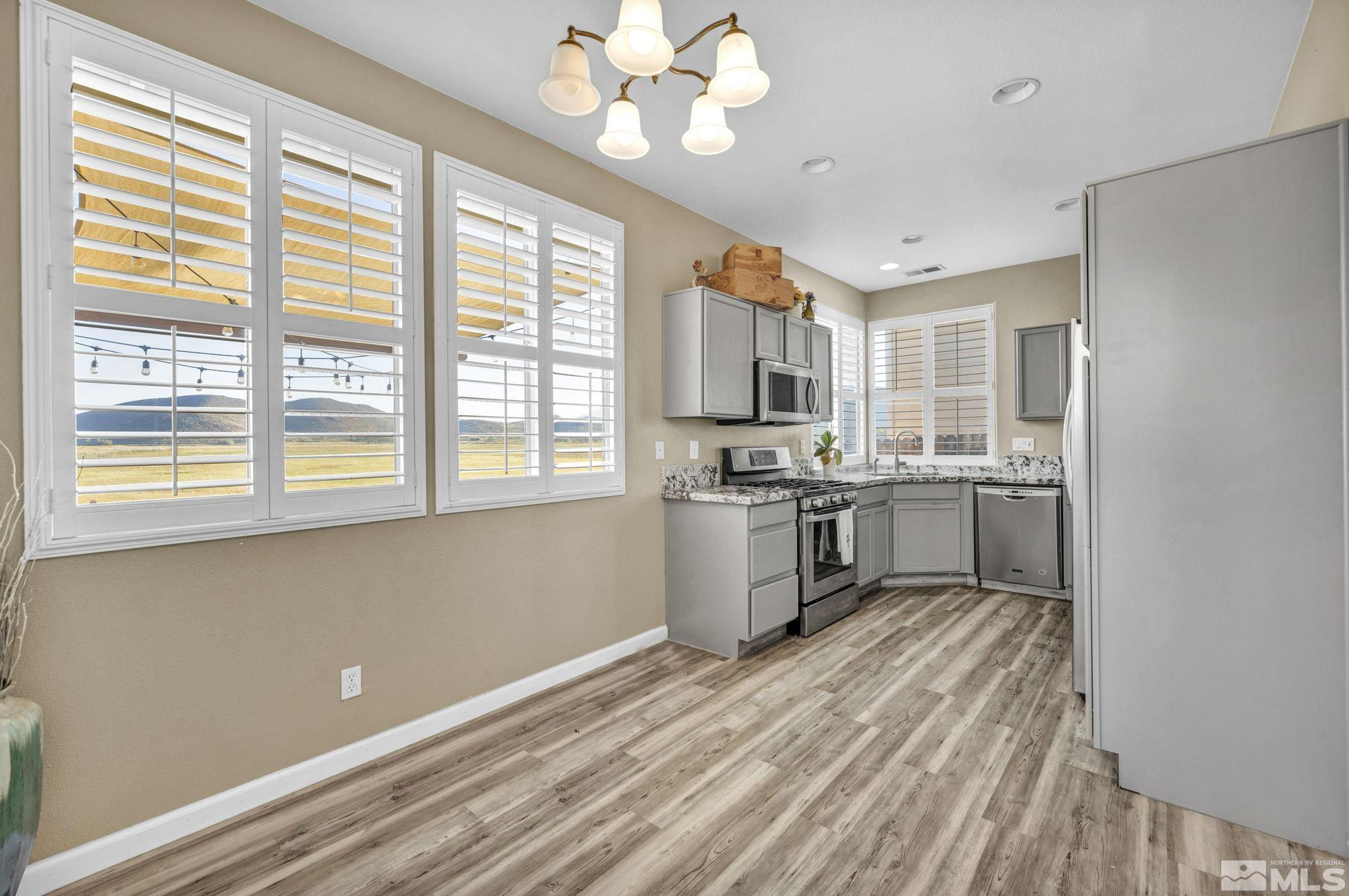 3713 Heron's Landing Drive Reno, NV 89502 - Photo 11 of 35 a kitchen with a stove a sink and a refrigerator