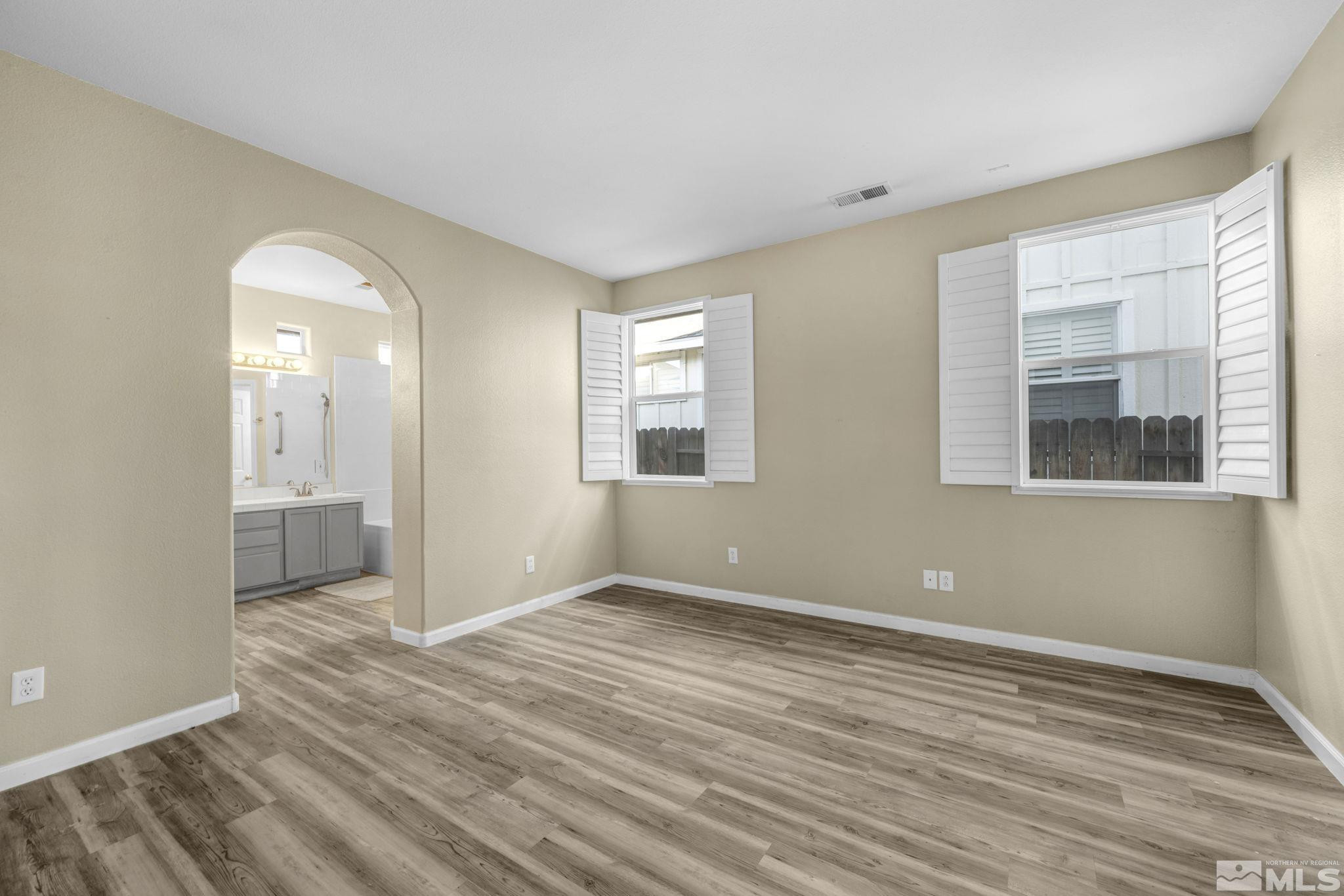 3713 Heron's Landing Drive Reno, NV 89502 - Photo 16 of 35 a view of empty room with wooden floor and fan