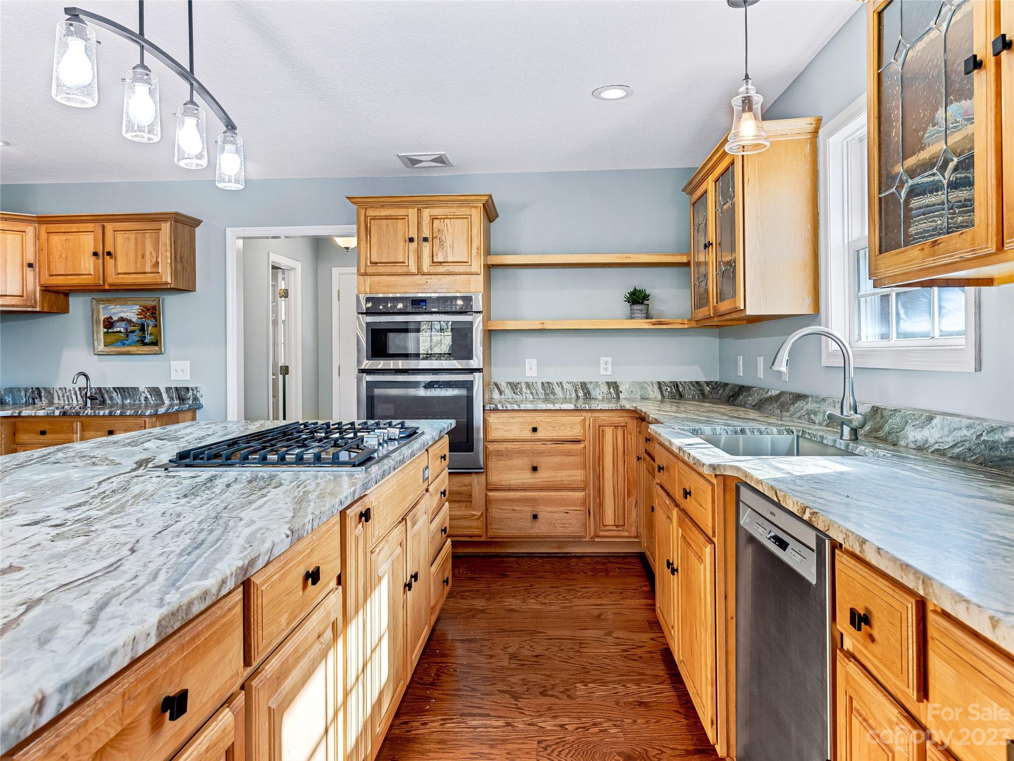 263 Sylvan Lane Mill Spring, NC 28756 - Photo 16 of 45 a kitchen with stainless steel appliances granite countertop a stove and a sink