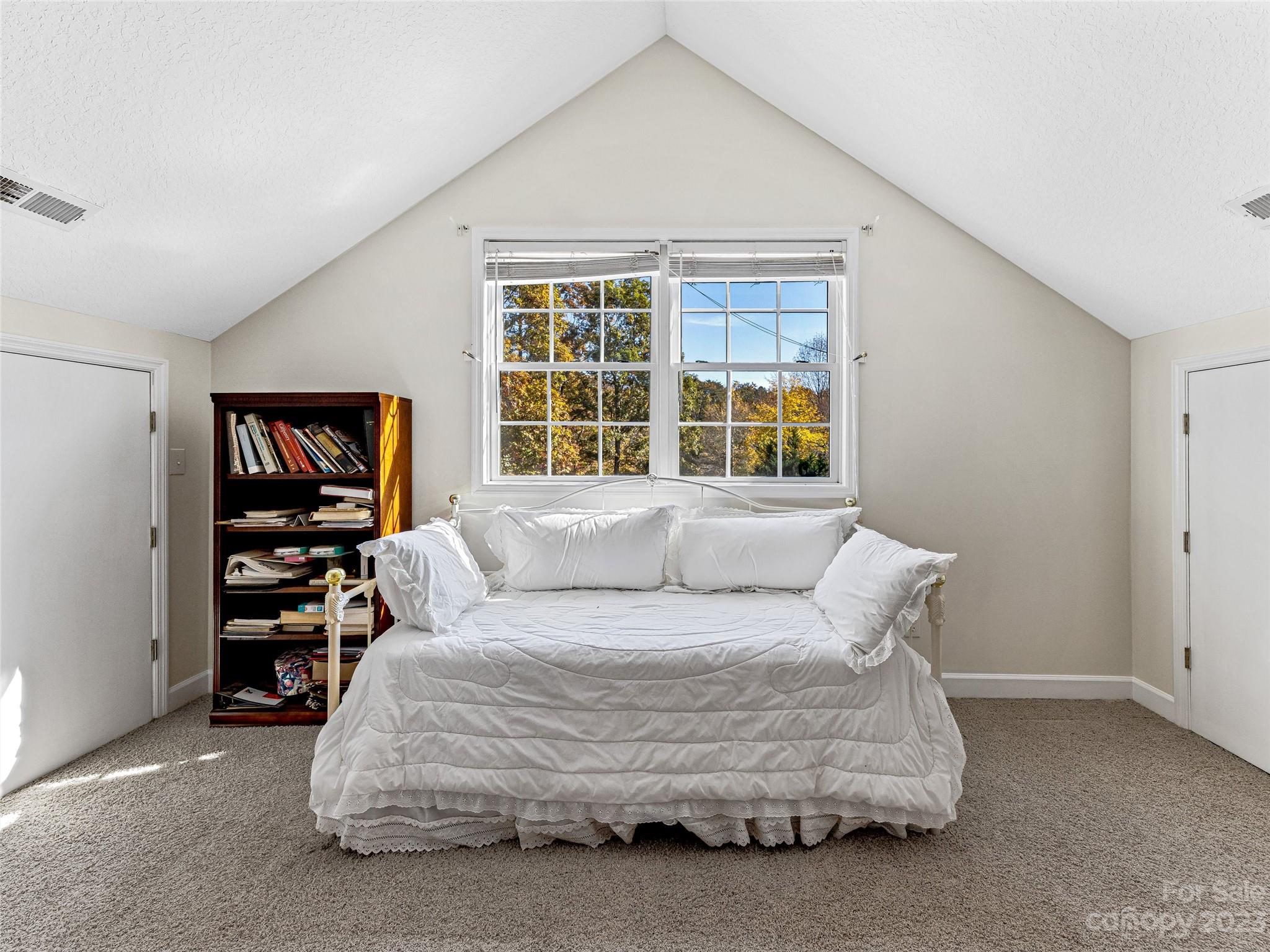 263 Sylvan Lane Mill Spring, NC 28756 - Photo 23 of 45 a bedroom with a bed a couch and a window